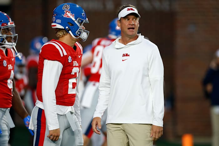 Oct 28, 2023; Oxford, Mississippi, USA; Mississippi Rebels head coach Lane Kiffin (right) talks with quarterback Jaxson Dart (2) during warm ups prior to the game against the Vanderbilt Commodores at Vaught-Hemingway Stadium. Mandatory Credit: Petre Thomas-USA TODAY Sports